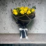 Timeless Yellow Arrangement: Sunny Yellow Roses with Eucalyptus in Black and White