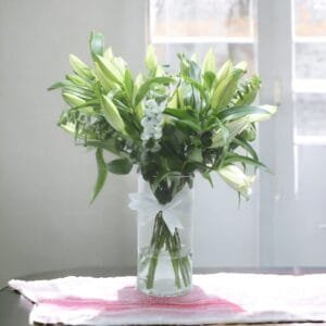 Sunny White Lily Cylinder Bouquet: Classic Arrangement of 10 White Lilies with Eucalyptus Accent