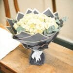 Creme Rose Ensemble: Classic Bouquet with Eucalyptus in Black Wrapping and White Ribbon