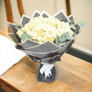 Creme Rose Ensemble: Classic Bouquet with Eucalyptus in Black Wrapping and White Ribbon
