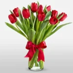 Love Bloom: 10 Red Tulips in Cylinder Vase with Red Ribbon Bow