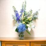 Bluesky Delight, Cylinder Vase Bouquet: Lily, Hydrangea, Creme Roses, Eucalyptus Touch