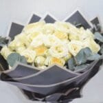 Creme Rose Ensemble: Classic Bouquet with Eucalyptus in Black Wrapping and White Ribbon