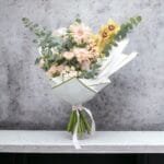 Morning Sun Delight: Cymbidium, Gerbera, Spray Rose, and Rose Pink Bouquet with Eucalyptus, White Wrapping, Pink Ribbon