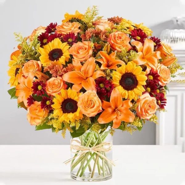 Grand Sunshine: A Radiant Floral Arrangement ? Sunflowers, Orange Roses, Orange Lilies, Red Chrysanthemums, Orange Chrysanthemums, Salal Tip, Solidaster, Cylinder Glass Vase