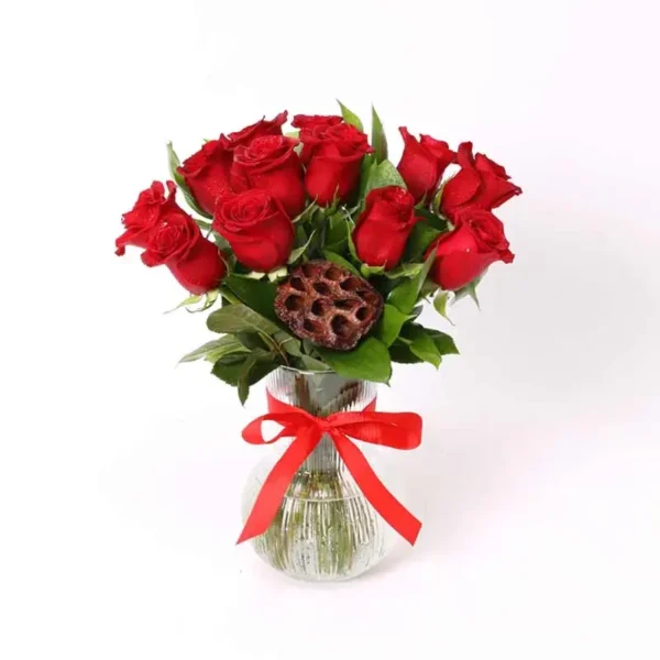 Honey Red Roses: Sweet Vase Ensemble ? 11 Red Roses, Single Ruscus, Dry Lotus Flower, Clear Glass Vase, Ribbon Bow
