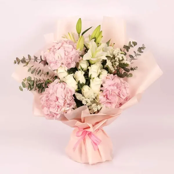 Pastel Paradise Bouquet: Pink Hydrangeas, White Roses, White Oriental Lilies, White Statice, Baby Blue Eucalyptus | Peach Wrap, Pink Ribbon Bow