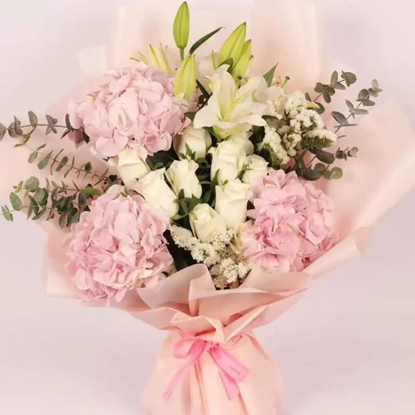 Pastel Paradise Bouquet: Pink Hydrangeas, White Roses, White Oriental Lilies, White Statice, Baby Blue Eucalyptus | Peach Wrap, Pink Ribbon Bow