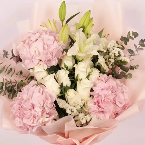 Pastel Paradise Bouquet: Pink Hydrangeas, White Roses, White Oriental Lilies, White Statice, Baby Blue Eucalyptus | Peach Wrap, Pink Ribbon Bow