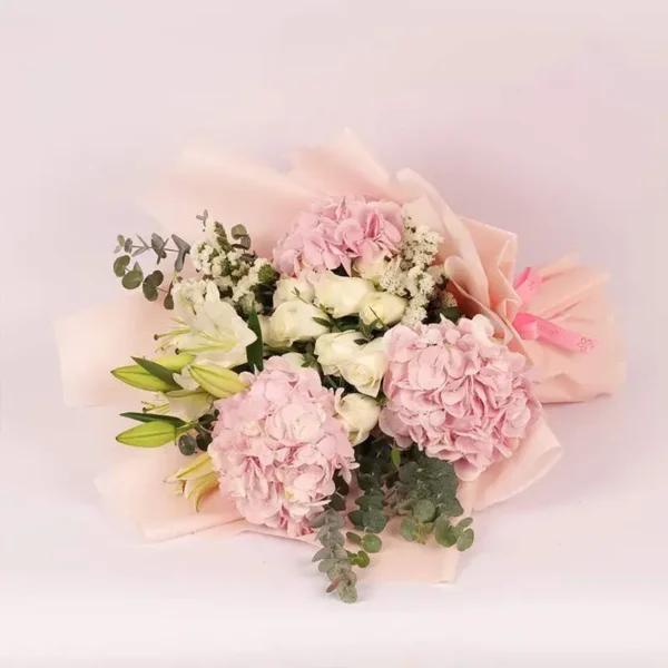 Pastel Paradise Bouquet: Pink Hydrangeas, White Roses, White Oriental Lilies, White Statice, Baby Blue Eucalyptus | Peach Wrap, Pink Ribbon Bow