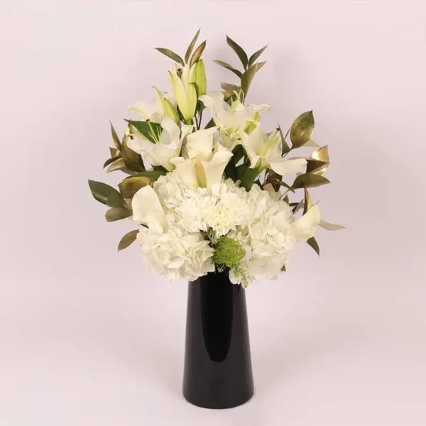 Serene Blooms: A Tranquil Display in Black Glass Vase - White Oriental Lilies, Hydrangeas, Calla Lilies, Carnations