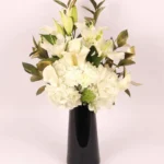 Serene Blooms: A Tranquil Display in Black Glass Vase - White Oriental Lilies, Hydrangeas, Calla Lilies, Carnations