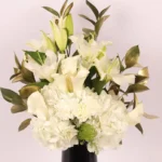 Serene Blooms: A Tranquil Display in Black Glass Vase - White Oriental Lilies, Hydrangeas, Calla Lilies, Carnations