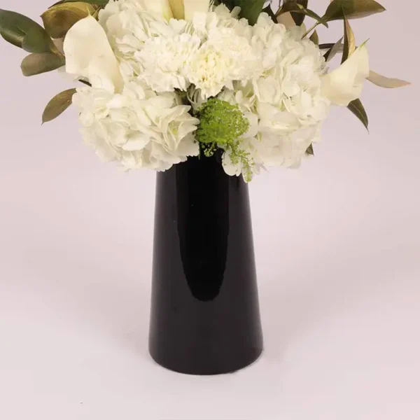 Serene Blooms: A Tranquil Display in Black Glass Vase - White Oriental Lilies, Hydrangeas, Calla Lilies, Carnations
