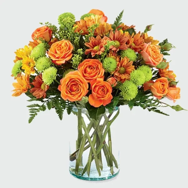 Sunset Floral Paradise: Blooms in Glass Vase - Orange Spray Roses, Chrysanthemums, Green Button Chrysanthemums, Leather Fern, Solidaster