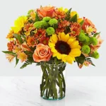 Vibrant Blooms: A Stunning Floral Arrangement - Orange Roses, Sunflowers, Chrysanthemums, Alstroemeria, Green Button Chrysanthemums, Leather Fern Leaves, Glass Vase