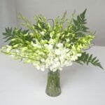 Elegant White Dendrobium Orchids with Leather Leaves in Cylinder Vase ? Sophisticated Floral Arrangement